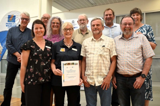 Staff and volunteers accept the organisation’s award from Darren West MLC