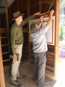 Paul and Paul install a new noticeboard
