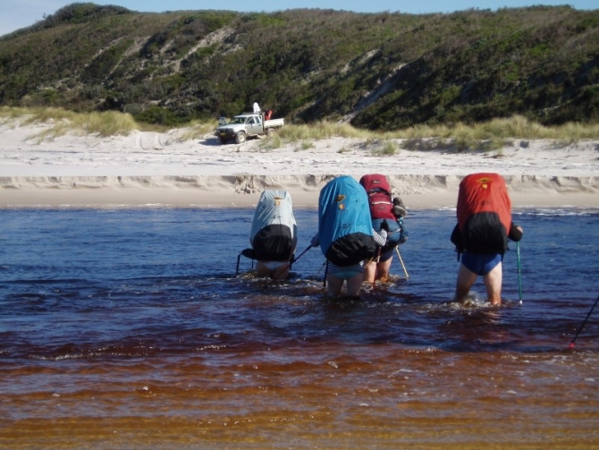 Wading across the inlet by hikers.